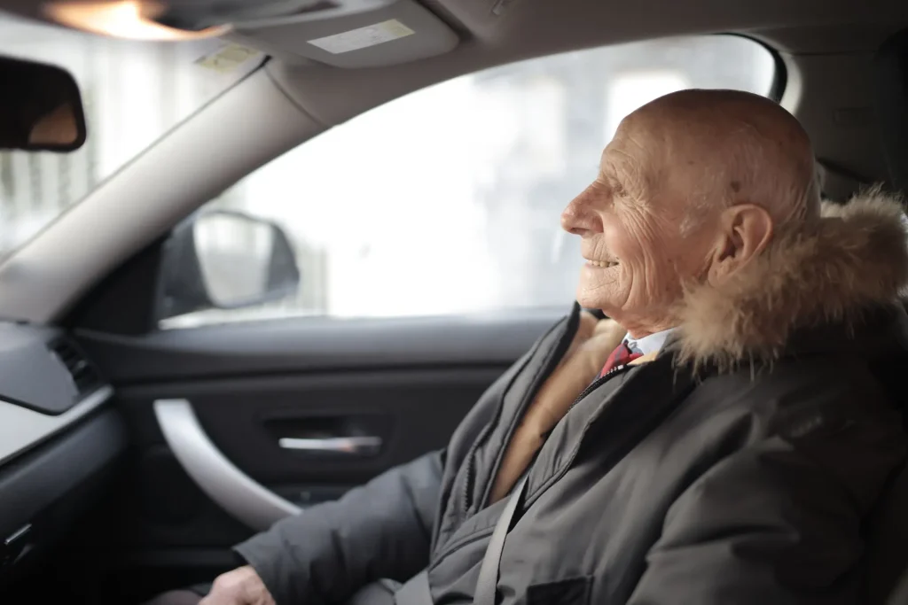 Senior man riding in a car
